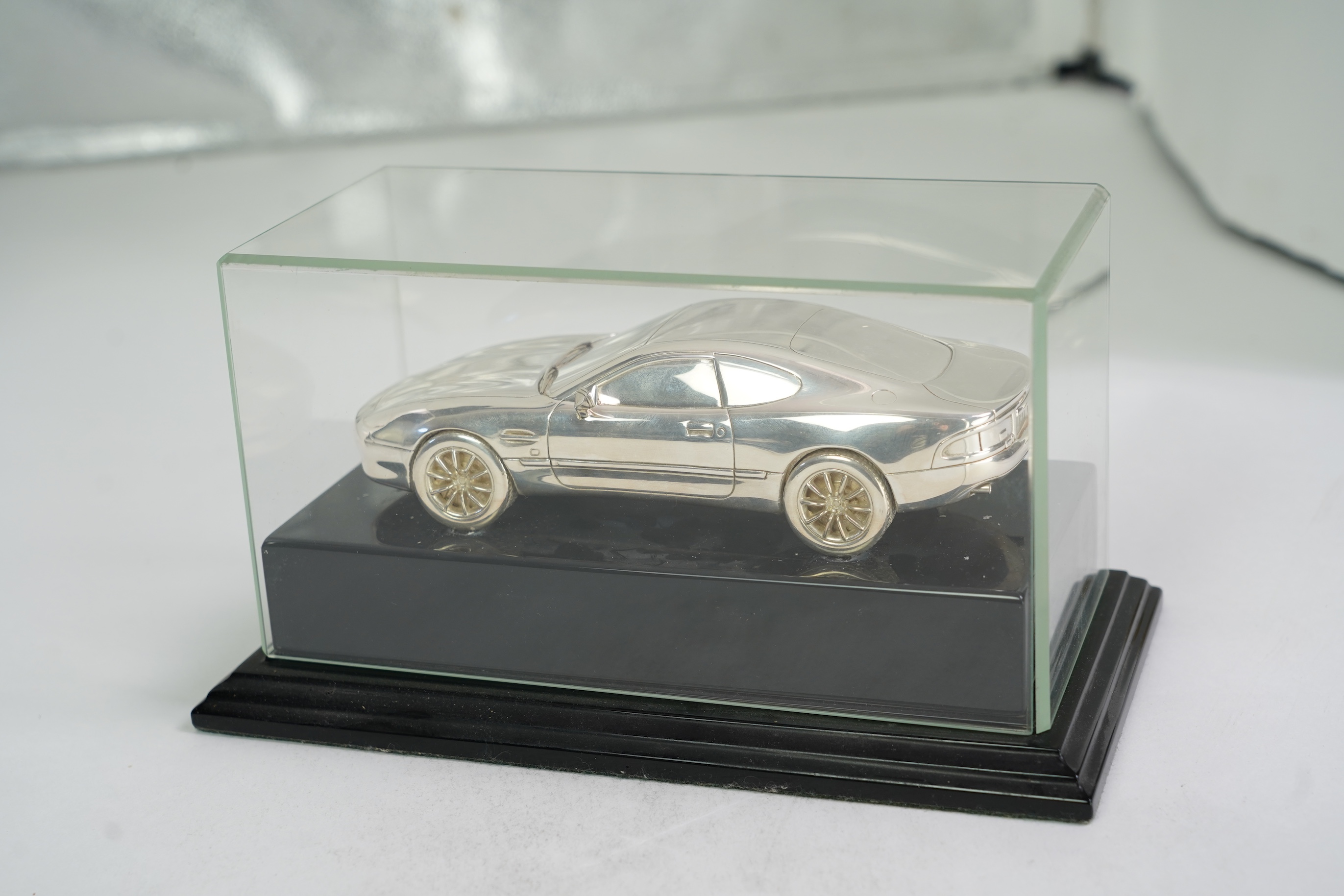 An Elizabeth II miniature silver model of an Aston Martin DB7 Vantage, by Aston Martin Lagonda Design Ltd